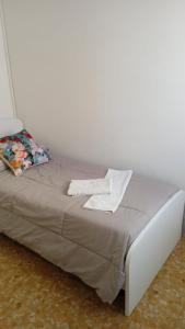 a bed with two pillows on top of it at Gabrielli Rooms & Apartments - FIERA in Verona