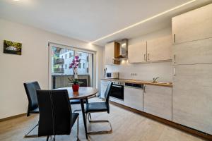 a kitchen with a table and chairs in a room at Ferienwohnung Lamm 3 in San Valentino alla Muta +6 photos