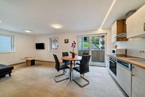 a kitchen and living room with a table and chairs at Ferienwohnung Lamm 3 in San Valentino alla Muta