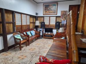 a living room with a couch and a table and chairs at Josephine's Villa - Bangar, LU (up to 15 guests) in Bangar