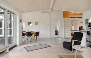 a living room and dining room with a table and chairs at Awesome Home In Græsted With Wifi in Græsted