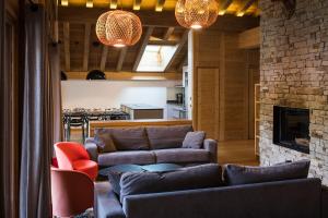 a living room with two couches and a fireplace at Les Cimes in La Clusaz