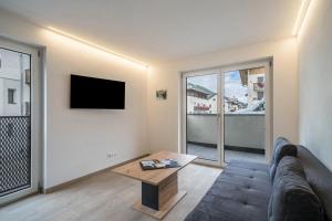 a living room with a couch and a tv at Ferienwohnung Lamm 4 in San Valentino alla Muta