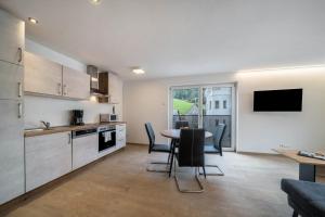 a kitchen and living room with a table and chairs at Ferienwohnung Lamm 4 in San Valentino alla Muta