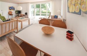 a living room with a table and chairs at Nice Home In Sydals With Kitchen in Vollerup