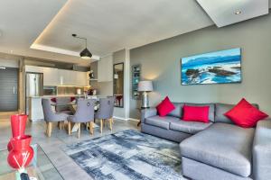 a living room with a couch and a table at Chelsea on Main in Cape Town