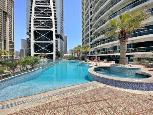 a large swimming pool in the middle of a building at StoneTree - 1BR apartment with Lake View in Dubai