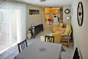 een woonkamer met een tafel en een bank bij La Saugelia votre maison avec piscine privative ! in Mouriès