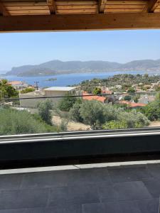 a large window with a view of the water at Zinia House in Porto Rafti +2 photos