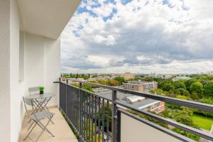 a balcony with a table and a view of the city at Family Apartment near Old Town by Renters in Warsaw