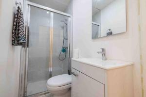 a bathroom with a shower and a toilet and a sink at Birgu 3 in Cospicua