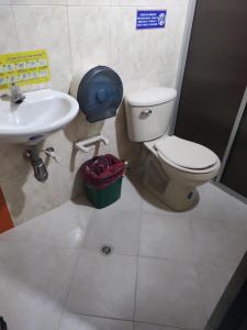 a bathroom with a toilet and a sink at Hotel Marat suite in Medellín