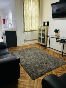 a living room with a couch and a rug at Coventry City House - Room 2 in Coventry