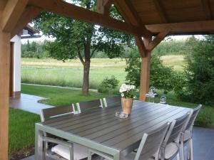 a wooden table with chairs and a vase of flowers at Rooms Gašper in Postojna