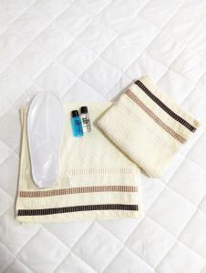 a towel and two bottles on a bed at Apartments Victory in Kavadarci