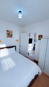 a bedroom with a large white bed and a room at Urban oasis40 in Talisay +9 photos