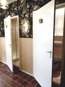 a bathroom with two open doors and a mirror at City Farmer-Amsterdam, Stay, Inn, Loft, Bed, Bike and Breakfast in Amsterdam