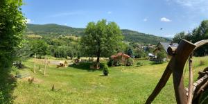 a view of a yard with trees and a house at Children Cottage Župkov - in gorgeous valley in Župkov