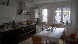 a kitchen with a table with chairs and a table and a tableablish at Cosy Room in Puchheim