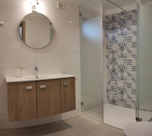 a bathroom with a shower and a sink and a mirror at 6 Bedroom Private Villa Tenazinha I, with private pool in Albufeira +19 photos