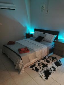 a bedroom with a bed with a black and white comforter at Oroklini Hideaway in Voroklini