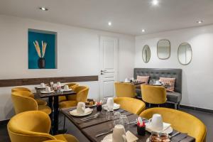 a dining room with tables and yellow chairs at Arc De Triomphe in Paris