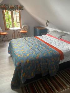 a bedroom with a bed and two chairs and a window at Mulleys Cottage (Bed and Breakfast) in Westleton