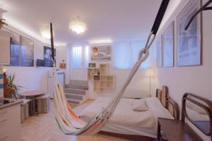 a room with a bed and a hammock in it at Film Poster or Coffee Basement Apartman with terrace in Budapest