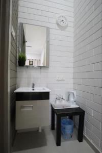 a bathroom with a sink and a mirror at Casa Tanjung Jara in Dungun