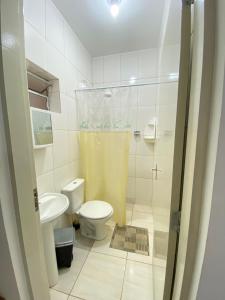 a bathroom with a toilet and a sink and a shower at CASA UBATUBA-MARANDUBA, casa térrea in Ubatuba