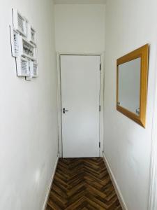 a hallway with a white door and a window at Coventry City House - Room 3 in Coventry