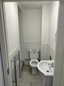 a white bathroom with a toilet and a sink at Coventry City House - Room 3 in Coventry