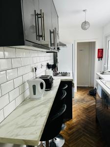 a kitchen with a counter with a large appliance on it at Coventry City House - Room 3 in Coventry