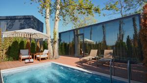 a house with a swimming pool and glass walls at Velour Hotel Spa Restaurant in Sakarya