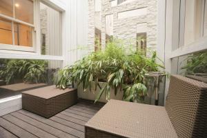 a balcony with chairs and plants on a building at The London Nest: 2BR City Haven in London