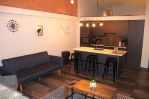 a living room and kitchen with a couch and a table at Heated Floors, High Ceiling, Open Plan, Cosy, Modern, Stylish Sheffield City Centre in Sheffield
