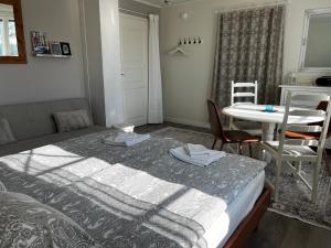 a bedroom with a bed and a table and chair at Moonloft@VillaSolbacka in Inkoo