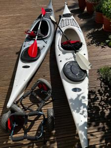 two kayaks sitting on a deck with a stroller at Moonloft@VillaSolbacka in Inkoo