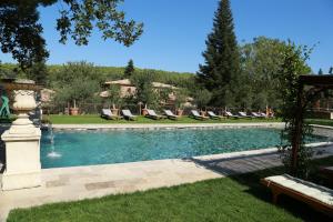 a swimming pool with lounge chairs in a yard at Chambre d'h&ocirc;tes Chez Samuel Bruno in Lorgues