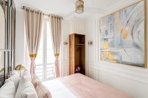 a bedroom with a bed and a window at Luxury 6 Bedroom 3 Bathroom Louvre Champs Elysees in Paris