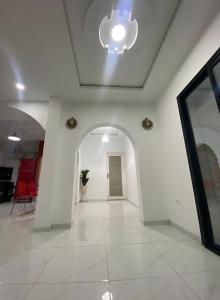 a white hallway with a ceiling with a light at Villa Maria & Nour in Awlād ‘Umar