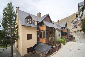 an old house with a roof on a street at Lebre by Totiaran in Naut Aran