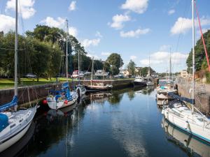 a group of boats are docked in a marina at 23 Beach Road in Y Felinheli