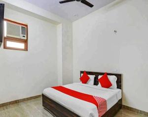 a bedroom with a large bed with red pillows at Hotel Sky Bird in Bhauli