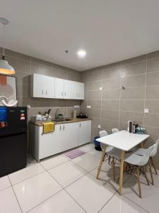 a kitchen with a table and a refrigerator and a table at Ins Design Lost World Of Tambun 2BR7pax in Ipoh