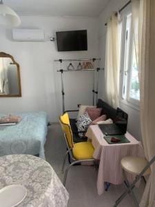 Habitación pequeña con mesa y cama en Παραθαλάσσιο στούντιο με κήπο, en Saronida