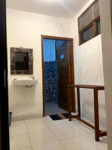 a bathroom with a sink and a mirror at Nawasena Ocean View in Toyapakeh