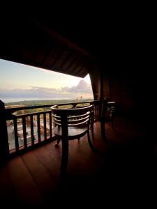 a view from a balcony of a table and chairs at Nawasena Ocean View in Toyapakeh