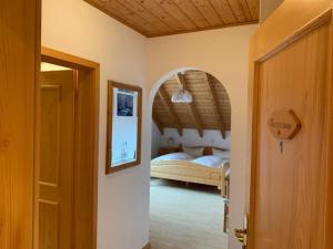 a bedroom with a bed and a room with a door at Landhaus Schneeberg in Mosbach