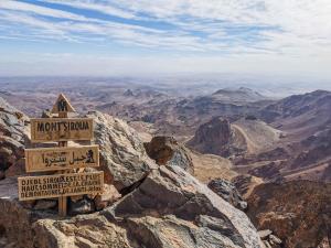 a sign on the top of a mountain at auberge le SIRWA SALAM in Ouarzazate